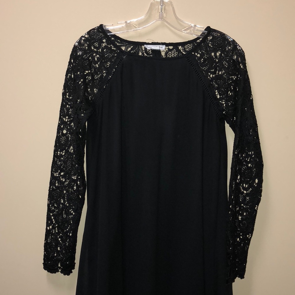 Black homecoming dress with long lace sleeves.